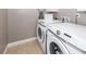 Efficient laundry room featuring modern washer and dryer units at 8745 Alexandria Dr, North Charleston, SC 29420
