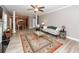 Bright living room with ceiling fan, hardwood floors, an area rug, and neutral paint at 8745 Alexandria Dr, North Charleston, SC 29420