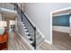Elegant staircase with carpeted steps and stylish black metal railings, open floor plan at 8745 Alexandria Dr, North Charleston, SC 29420