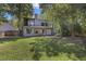 Large backyard featuring healthy lawn and trees, with the home's siding in the background at 9 Stallion Ct, Charleston, SC 29407