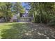 View of backyard with grassy lawn and mature trees at 9 Stallion Ct, Charleston, SC 29407