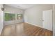 Bedroom featuring hardwood floors, bright windows, and white door at 9 Stallion Ct, Charleston, SC 29407