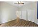 Bright bedroom with wood floors, ceiling fan, and closet doors at 9 Stallion Ct, Charleston, SC 29407