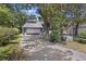 Two-story home with a driveway leading to an attached garage and surrounded by mature trees at 9 Stallion Ct, Charleston, SC 29407