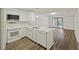 Well-lit kitchen featuring wood flooring, white countertops and appliances, and recessed lighting at 9 Stallion Ct, Charleston, SC 29407