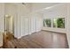 Open floor plan living room with hardwood floors and natural lighting from the three windows at 9 Stallion Ct, Charleston, SC 29407