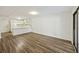 Bright living room showcasing wood flooring, a door, and a view of the kitchen at 9 Stallion Ct, Charleston, SC 29407