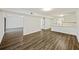 Bright living room view showcasing wood flooring and access to the kitchen at 9 Stallion Ct, Charleston, SC 29407