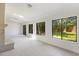 Bright living room features neutral tile, brick fireplace and large windows overlooking the landscaped backyard at 9 Stallion Ct, Charleston, SC 29407