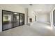 Sunlit living room showcases brick fireplace, tile flooring, and sliding door access to the backyard at 9 Stallion Ct, Charleston, SC 29407