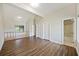 Spacious living room with hardwood flooring, vaulted ceilings, and access to bathroom at 9 Stallion Ct, Charleston, SC 29407