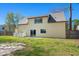 A home's backyard with a well-kept lawn and a sliding glass door for easy access at 100 Traders Station Rd, Summerville, SC 29486