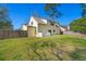 A home's backyard with a well-kept lawn and a traditional fence providing privacy at 100 Traders Station Rd, Summerville, SC 29486