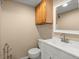 Well-lit half bathroom features a modern sink and fixtures, with natural wood cabinets at 100 Traders Station Rd, Summerville, SC 29486