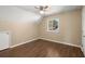 Well lit bedroom features wood look flooring and a window with treeline views at 100 Traders Station Rd, Summerville, SC 29486