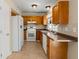Cozy kitchen with wooden cabinets, tile flooring, and white appliances at 100 Traders Station Rd, Summerville, SC 29486