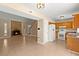 Open-concept living room and kitchen with a stone fireplace and tile flooring at 100 Traders Station Rd, Summerville, SC 29486