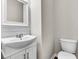 Charming powder room with white vanity, mirror, and shiplap accent wall at 105 Endicott Ct, Summerville, SC 29486