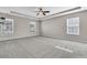 Open bedroom with trey ceiling, multiple windows, and ceiling fan at 105 Endicott Ct, Summerville, SC 29486