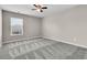 Neutral bedroom featuring a ceiling fan, plush carpet, and a window for natural light at 105 Endicott Ct, Summerville, SC 29486