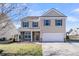 Charming two-story home featuring stone accents, neutral siding, and a well-manicured front lawn under a clear blue sky at 105 Endicott Ct, Summerville, SC 29486