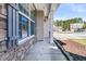 Welcoming front porch with stone accents, a view of the neighborhood street, and tidy garden bed at 105 Endicott Ct, Summerville, SC 29486