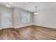 Bright living room with hardwood floors, modern light fixtures, and neutral paint, inviting design at 105 Endicott Ct, Summerville, SC 29486