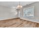 Living room with hardwood floors, modern light fixture, and neutral paint, creating a clean and airy space at 105 Endicott Ct, Summerville, SC 29486