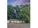 Charming one-story home nestled among tall trees with a brick facade and inviting front entrance at 106 Shirley Dr, Ladson, SC 29456