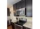 Well-equipped kitchen boasts stainless steel appliances and sleek dark cabinetry, enhancing the cooking experience at 106 Shirley Dr, Ladson, SC 29456