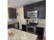 Modern kitchen features stainless steel appliances, granite countertops, and ample cabinet space at 106 Shirley Dr, Ladson, SC 29456