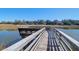 Waterfront dock with weathered wood, providing access and scenic views at 1142 Village Creek Ln # 3, Mount Pleasant, SC 29464