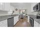 Bright kitchen with stainless steel appliances, granite counters, and an adjacent dining area at 1142 Village Creek Ln # 3, Mount Pleasant, SC 29464
