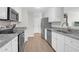 Spotless white kitchen featuring granite countertops and modern stainless steel appliances at 1142 Village Creek Ln # 3, Mount Pleasant, SC 29464