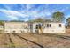 Backyard view with sliding glass door and wooden stairs highlighting the expansive yard and outdoor living space at 116 Wisteria Falls Trl, Saint Stephen, SC 29479