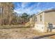 Backyard view featuring a wooden staircase, showcasing the home's light siding and outdoor potential at 116 Wisteria Falls Trl, Saint Stephen, SC 29479