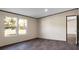 A sunny bedroom with large double windows, vinyl floors, and light-colored walls at 116 Wisteria Falls Trl, Saint Stephen, SC 29479