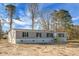 Stylish single-story home showcasing gray siding, black shutters, and a welcoming front entry with natural wood stairs at 116 Wisteria Falls Trl, Saint Stephen, SC 29479