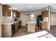 Functional kitchen with wood cabinets, a stone countertop island, and stainless appliances perfect for cooking and entertaining at 116 Wisteria Falls Trl, Saint Stephen, SC 29479