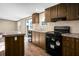Modern kitchen boasts a black oven and dishwasher, ample countertop space, and sleek cabinetry at 116 Wisteria Falls Trl, Saint Stephen, SC 29479