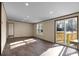 Sunlit living area with wood-look flooring, sliding glass doors to outdoor deck, and recessed lighting at 116 Wisteria Falls Trl, Saint Stephen, SC 29479