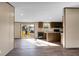 Open floor plan connecting the living room to a modern kitchen, enhanced by wood flooring and bright, natural light at 116 Wisteria Falls Trl, Saint Stephen, SC 29479