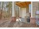 Covered back porch with exposed structural elements surrounded by natural woods at 1204 Dingle Rd, Mount Pleasant, SC 29466