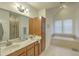 Bright bathroom featuring double sinks, soaking tub and glass enclosed shower at 1204 Dingle Rd, Mount Pleasant, SC 29466