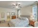 Inviting bedroom featuring a comfortable bed, ceiling fan, and ensuite bath with tub at 1204 Dingle Rd, Mount Pleasant, SC 29466