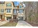 Two-story townhome with yellow and tan siding, attached garages, and a well-maintained lawn at 1204 Dingle Rd, Mount Pleasant, SC 29466
