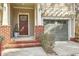 Charming entrance featuring a brown door, brick detailing, and an attached garage at 1204 Dingle Rd, Mount Pleasant, SC 29466