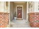 Inviting front porch with brick accents and a decorative wreath on the front door at 1204 Dingle Rd, Mount Pleasant, SC 29466