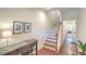Hallway with stairs, hardwood floors, and wall art leading to other rooms at 1204 Dingle Rd, Mount Pleasant, SC 29466