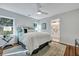 Bright bedroom with hardwood floors, ceiling fan, and ensuite bathroom at 1251 Wisteria Rd, Charleston, SC 29407